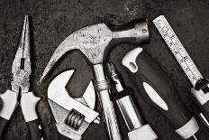 Black and White Image of a Set of Tools on a Textured Metallic Background-Kamira-Photographic Print