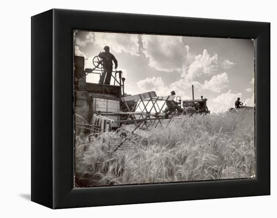 Kansas Farmer Driving Farmall Tractor as He Pulls a Manned Combine During Wheat Harvest-Margaret Bourke-White-Framed Premier Image Canvas