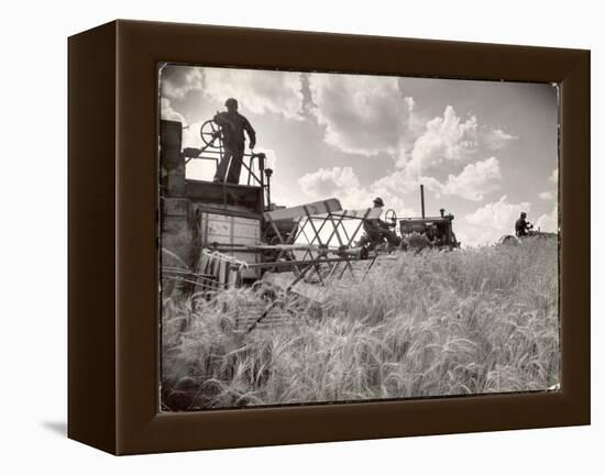 Kansas Farmer Driving Farmall Tractor as He Pulls a Manned Combine During Wheat Harvest-Margaret Bourke-White-Framed Premier Image Canvas