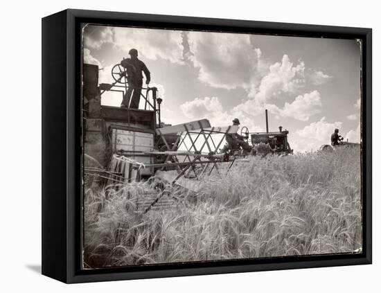 Kansas Farmer Driving Farmall Tractor as He Pulls a Manned Combine During Wheat Harvest-Margaret Bourke-White-Framed Premier Image Canvas