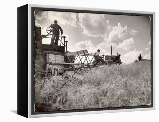 Kansas Farmer Driving Farmall Tractor as He Pulls a Manned Combine During Wheat Harvest-Margaret Bourke-White-Framed Premier Image Canvas