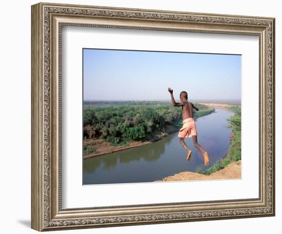 Karo Boy Leaps Off a Cliff Over the Omo River, Ethiopia-Janis Miglavs-Framed Photographic Print