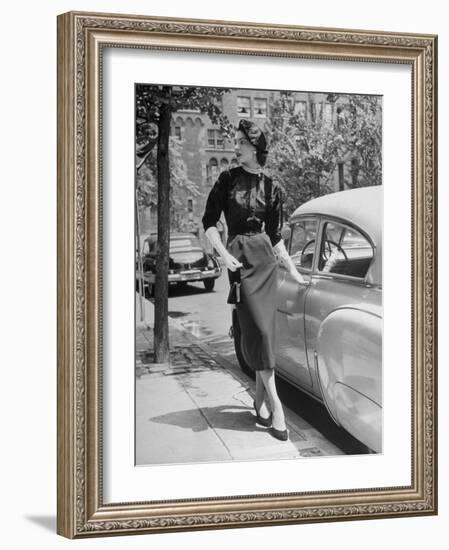 Katherine Cassidy Wearing a Red Fraostmann Wool Skirt and Black Sweater Beneath Black Cardigan-Nina Leen-Framed Photographic Print