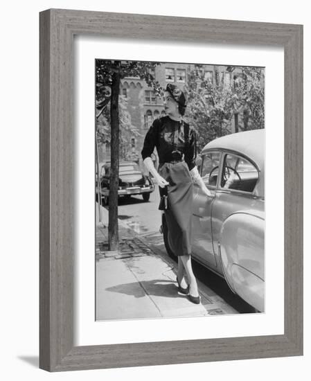 Katherine Cassidy Wearing a Red Fraostmann Wool Skirt and Black Sweater Beneath Black Cardigan-Nina Leen-Framed Photographic Print