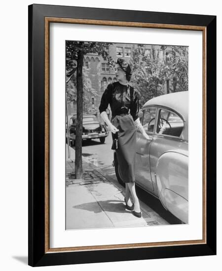 Katherine Cassidy Wearing a Red Fraostmann Wool Skirt and Black Sweater Beneath Black Cardigan-Nina Leen-Framed Photographic Print