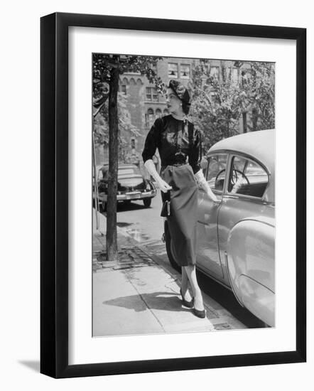 Katherine Cassidy Wearing a Red Fraostmann Wool Skirt and Black Sweater Beneath Black Cardigan-Nina Leen-Framed Photographic Print