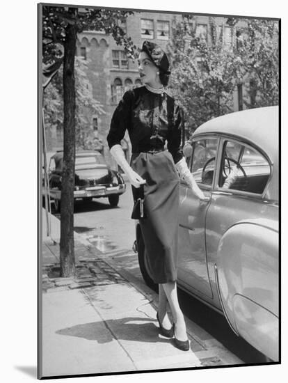 Katherine Cassidy Wearing a Red Fraostmann Wool Skirt and Black Sweater Beneath Black Cardigan-Nina Leen-Mounted Photographic Print