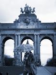 Belgium, Brussels; a Girl Walking with an Umbrella in Front of the Arc Du Triomphe-Ken Sciclina-Photographic Print