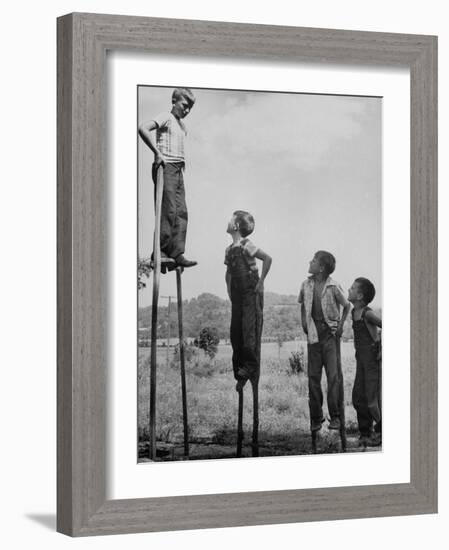 Kenneth Merriman on higher stilts than his brothers and friend-Robert W^ Kelley-Framed Photographic Print