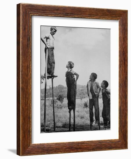 Kenneth Merriman on higher stilts than his brothers and friend-Robert W^ Kelley-Framed Photographic Print