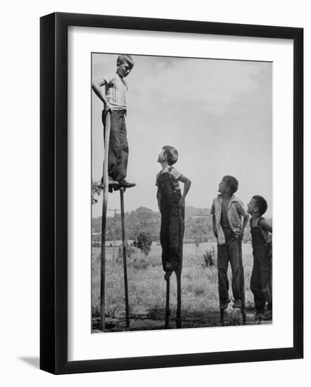 Kenneth Merriman on higher stilts than his brothers and friend-Robert W^ Kelley-Framed Photographic Print