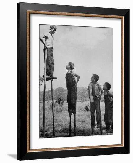 Kenneth Merriman on higher stilts than his brothers and friend-Robert W^ Kelley-Framed Photographic Print