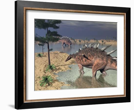 Kentrosaurus Dinosaurs Walking in the Water Next to Sand and Trees-null-Framed Art Print