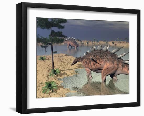 Kentrosaurus Dinosaurs Walking in the Water Next to Sand and Trees-null-Framed Art Print