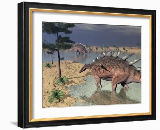 Kentrosaurus Dinosaurs Walking in the Water Next to Sand and Trees-null-Framed Art Print