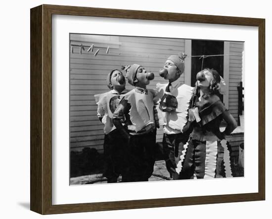 Kids Biting Apples on Strings at Halloween-null-Framed Photo