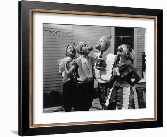 Kids Biting Apples on Strings at Halloween-null-Framed Photo