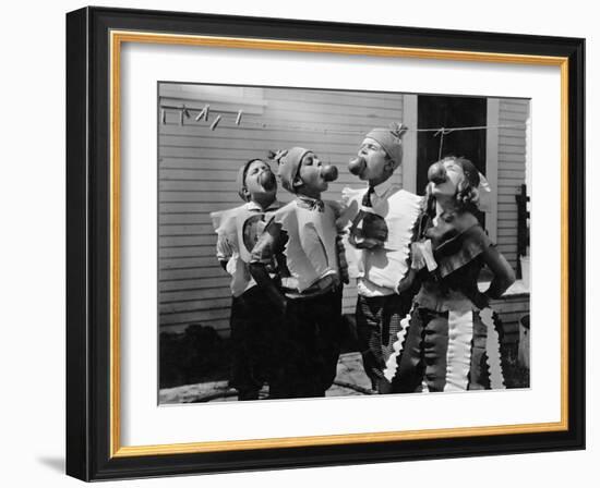 Kids Biting Apples on Strings at Halloween-null-Framed Photo