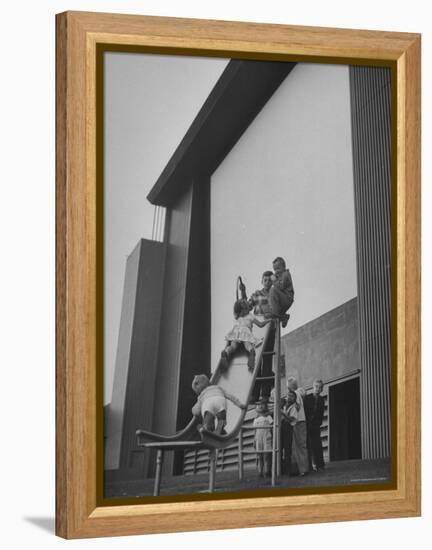 Kids Enjoying Slide in Mini Playground in Front of Rancho Drive-Allan Grant-Framed Premier Image Canvas