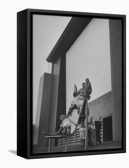 Kids Enjoying Slide in Mini Playground in Front of Rancho Drive-Allan Grant-Framed Premier Image Canvas