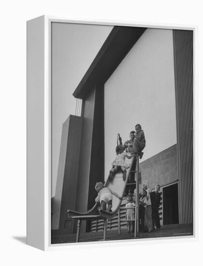 Kids Enjoying Slide in Mini Playground in Front of Rancho Drive-Allan Grant-Framed Premier Image Canvas