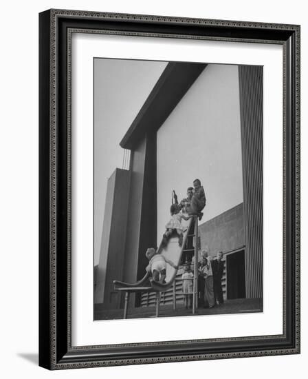 Kids Enjoying Slide in Mini Playground in Front of Rancho Drive-Allan Grant-Framed Photographic Print