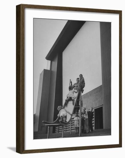 Kids Enjoying Slide in Mini Playground in Front of Rancho Drive-Allan Grant-Framed Photographic Print