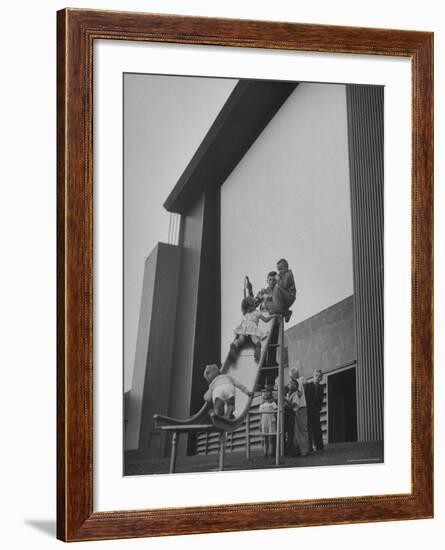 Kids Enjoying Slide in Mini Playground in Front of Rancho Drive-Allan Grant-Framed Photographic Print