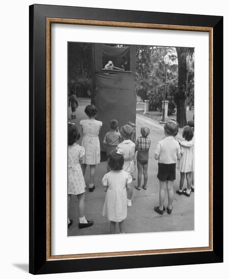 Kids Watching Outdoor Puppet Show-Dmitri Kessel-Framed Photographic Print