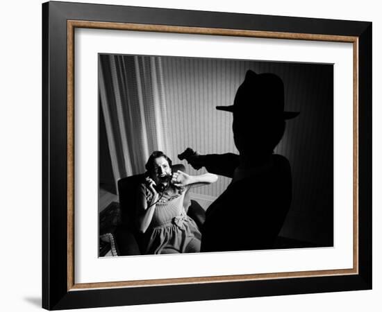 Killer Pointing the Gun at a Terrified Woman-stokkete-Framed Photographic Print