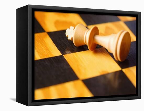 King chess piece lying on chessboard-null-Framed Premier Image Canvas