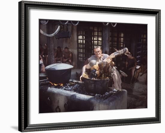 Kirk Douglas Dunking Enemy's Head in Giant Cook Pot in Scene From Stanley Kubrick's "Spartacus"-J^ R^ Eyerman-Framed Premium Photographic Print