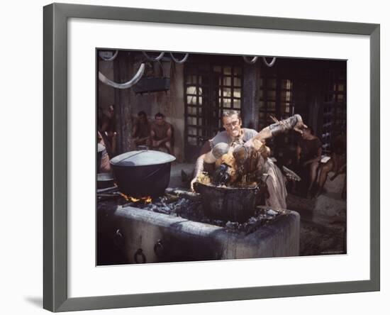 Kirk Douglas Dunking Enemy's Head in Giant Cook Pot in Scene From Stanley Kubrick's "Spartacus"-J^ R^ Eyerman-Framed Premium Photographic Print