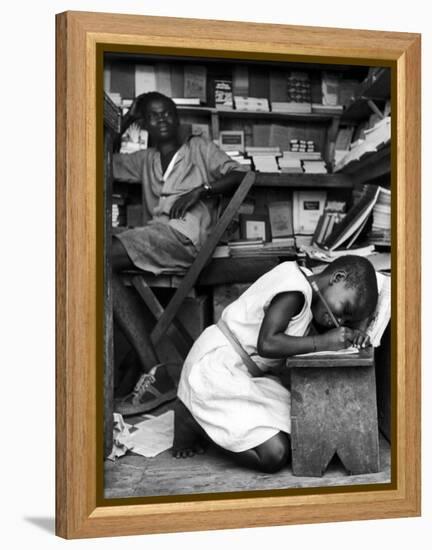 Kneeling Schoolgirl Writing on Wooden Bench. Accura, Gold Coast, Ghana-Alfred Eisenstaedt-Framed Premier Image Canvas