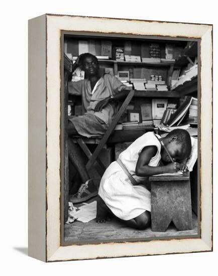 Kneeling Schoolgirl Writing on Wooden Bench. Accura, Gold Coast, Ghana-Alfred Eisenstaedt-Framed Premier Image Canvas