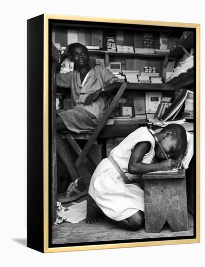 Kneeling Schoolgirl Writing on Wooden Bench. Accura, Gold Coast, Ghana-Alfred Eisenstaedt-Framed Premier Image Canvas