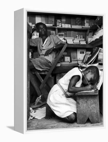 Kneeling Schoolgirl Writing on Wooden Bench. Accura, Gold Coast, Ghana-Alfred Eisenstaedt-Framed Premier Image Canvas