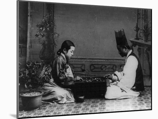 Korean Man and Woman Playing a Game Photograph - Korea-Lantern Press-Mounted Art Print
