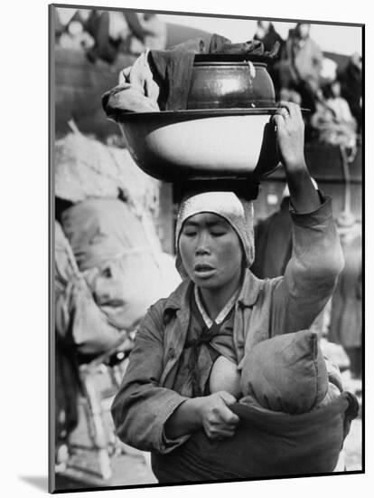 Korean Mother Nursing Her Baby, Carrying All Her Belongings in a Wash Basin, Retreating from Seoul-Carl Mydans-Mounted Photographic Print