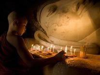 A Novice Monk Lighting Candles at a Massive Buddha Statue in Burma (Myanmar)-Kyle Hammons-Photographic Print