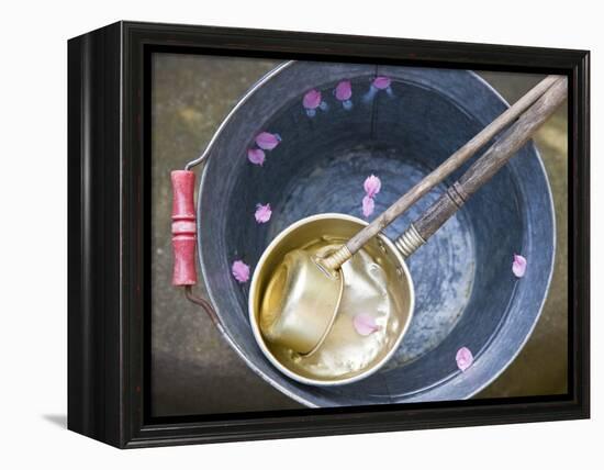 Ladling peach blossoms from a water pail-null-Framed Premier Image Canvas