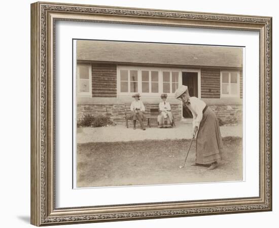 Lady Golfer Prepares to Putt as Two Seated Spectators Watch-null-Framed Photographic Print