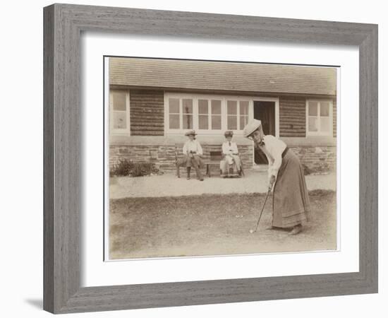 Lady Golfer Prepares to Putt as Two Seated Spectators Watch-null-Framed Photographic Print