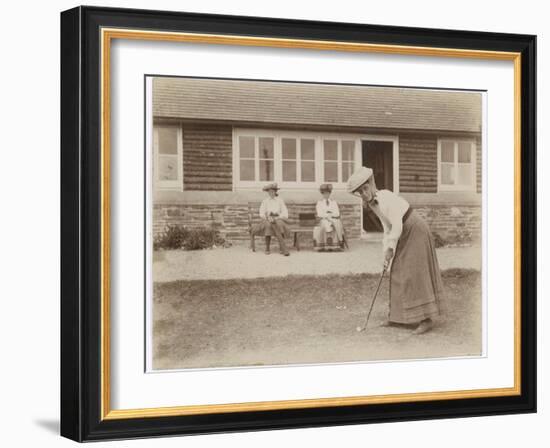 Lady Golfer Prepares to Putt as Two Seated Spectators Watch-null-Framed Photographic Print