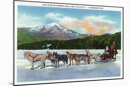 Lake Placid, New York - View of a Dogsled Team on Mirror Lake during Winter-Lantern Press-Mounted Art Print