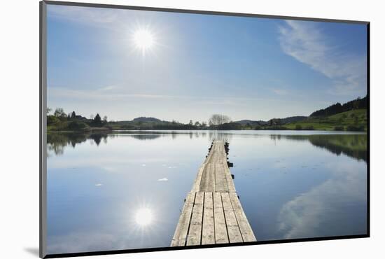 Lake with wooden jetty and sun, Muttelsee, Tettnang Baden-Wurttemberg, Germany-Raimund Linke-Mounted Photographic Print