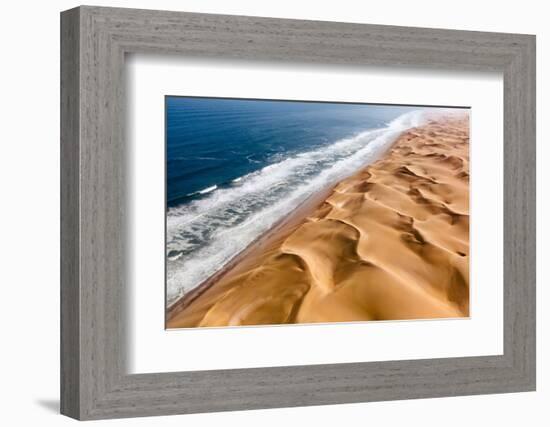 Langewand, Aerial view of where the Atlantic Ocean meets the sea of dunes in Western Namibia.-ClickAlps-Framed Photographic Print