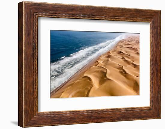 Langewand, Aerial view of where the Atlantic Ocean meets the sea of dunes in Western Namibia.-ClickAlps-Framed Photographic Print