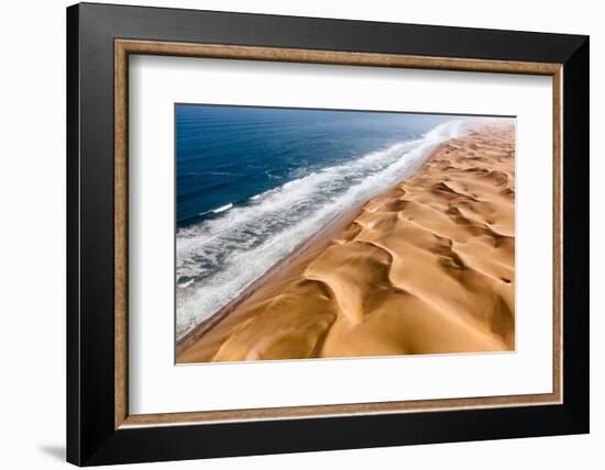 Langewand, Aerial view of where the Atlantic Ocean meets the sea of dunes in Western Namibia.-ClickAlps-Framed Photographic Print