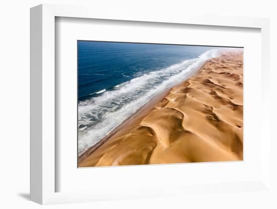 Langewand, Aerial view of where the Atlantic Ocean meets the sea of dunes in Western Namibia.-ClickAlps-Framed Photographic Print